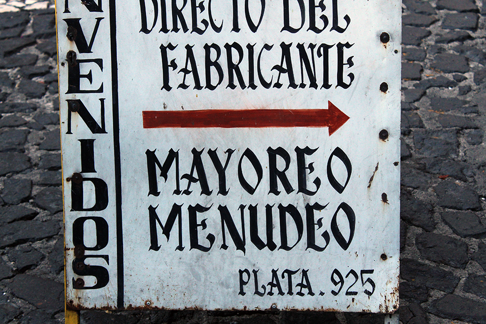 Handmade Taxco commercial sign with an inverted capital M.