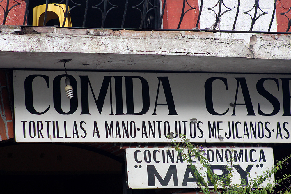 Handmade Taxco commercial sign with an inverted capital M.