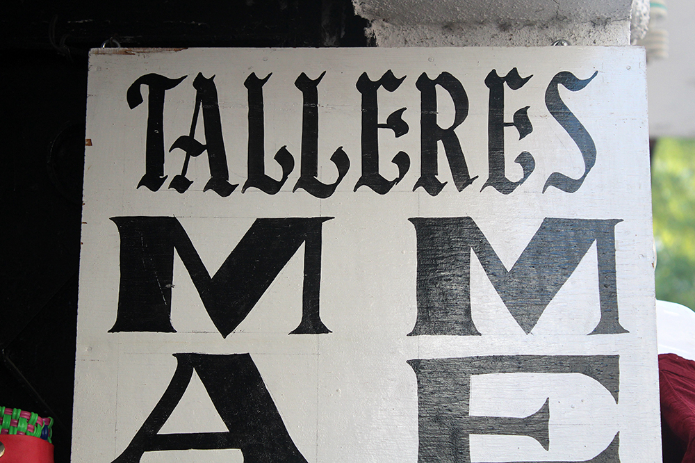 Handmade Taxco commercial sign with an inverted capital M.